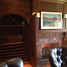 Quarter Sawn Oak library Cabinetry - Wine storage closet with round top doors, wainscot paneling, fireplace surround with hand carved Corbels